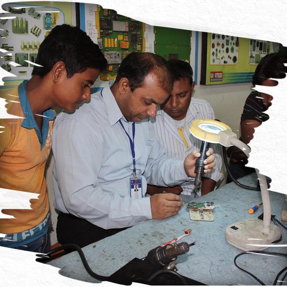 Students learning mobile phone repair at Saylani